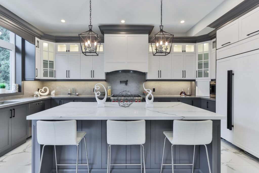 Renovated modern farmhouse kitchen in luxury home with grey and white design theme.
